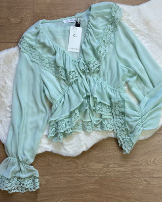 Blusa chiffon verde acqua con balze e pizzo